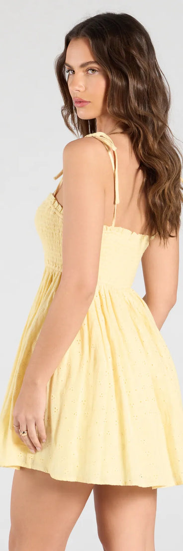 The Sunny Tones Smocked Eyelet Skater Dress in yellow brings sleek style to any graduation outfit, from cap and gown to after-party.