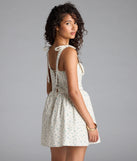 The Flower Fields Lace-Up Corset Skater Dress in ivory brings sleek style to any graduation outfit, from cap and gown to after-party.