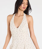 Make a bold statement in the Blissful Cutie Halter Button Floral Skater Dress in ivory, the perfect spring dress for weddings, cocktail hours, nights out, and/or seasonal celebrations.