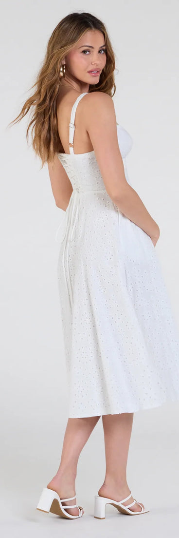Make a bold statement in the Sunny Staple Square Neck Eyelet Midi Dress With Pockets in white, the perfect summer dress for weddings, cocktail hours, nights out, and/or seasonal celebrations.