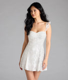 Shine with confidence, elegance, and standout style in the Enchanting Impression Butterfly Lace-Up Skater Dress—a white graduation dress designed with a fresh silhouette and the latest trends.