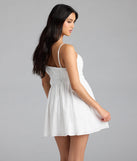 Soak up the season in the Here To Be Loved V-Neck Eyelet Skater Mini Dress, a white sundress styled for easy days, outdoor plans, and everything in between.