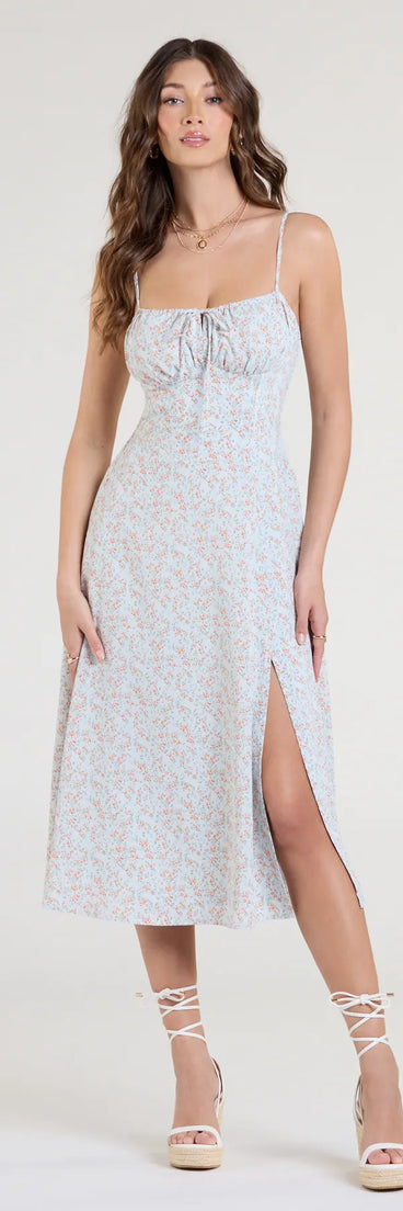 The Breezy Cute Floral Slit Midi Dress in light blue features a flattering fit and mid-calf hem, redefining effortless midi dresses for any occasion.