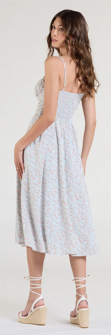 The Breezy Cute Floral Slit Midi Dress in light blue features a flattering fit and mid-calf hem, redefining effortless midi dresses for any occasion.