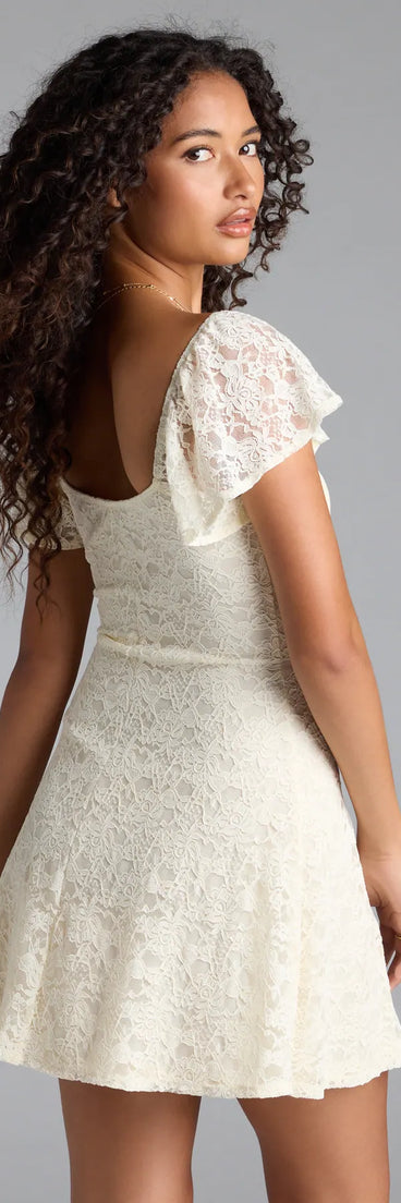 The Romantic Allure Flutter Sleeve A-Line Lace Mini Dress in ivory brings sleek style to any graduation outfit, from cap and gown to after-party.