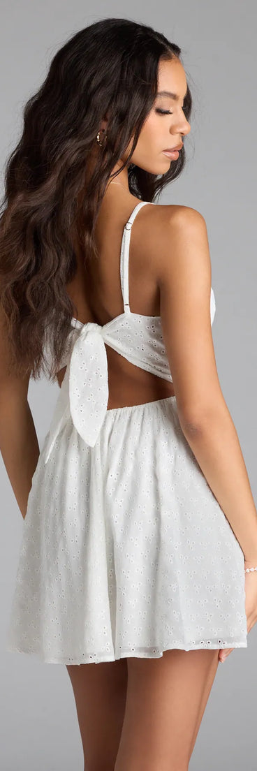 The Cute Thing Tie-Back Eyelet Skater Dress in white brings sleek style to any graduation outfit, from cap and gown to after-party.