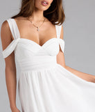 Shine with confidence, elegance, and standout style in the Flowy Chic Chiffon Cold-Shoulder Skater Dress—a white graduation dress designed with a fresh silhouette and the latest trends.