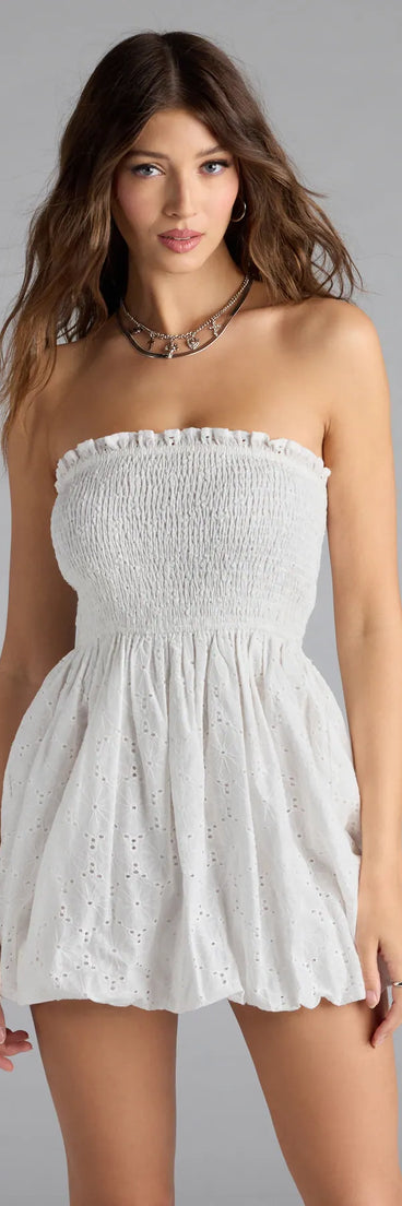 Soak up the season in the Effortless Eyelet Bubble Hem Mini Dress, a white sundress styled for easy days, outdoor plans, and everything in between.