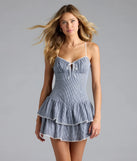 Step into summer looking effortlessly chic in the Such A Sweetie Open Back Gingham Ruffle Skater Dress in blue, a must-have Windsor dress for your warm-weather wardrobe.