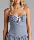 Step into summer looking effortlessly chic in the Such A Sweetie Open Back Gingham Ruffle Skater Dress in blue, a must-have Windsor dress for your warm-weather wardrobe.