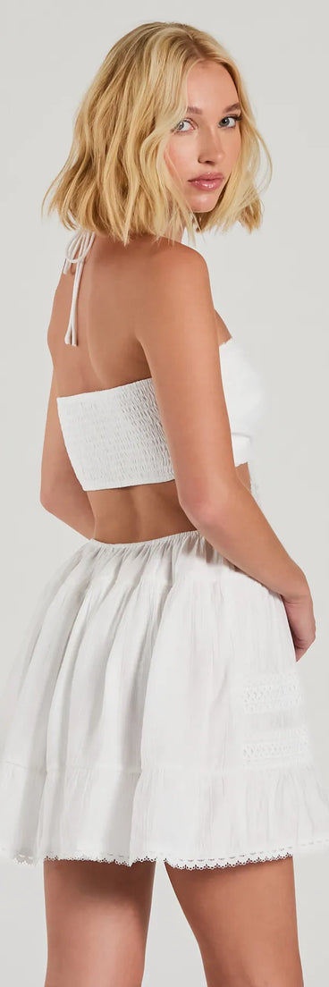 The Sweetie Status Halter Crochet Trim Babydoll Dress is a mini dress in white, perfect for an above-the-knee holiday party dress or a stylish NYE look, with a short hemline designed to make a winter statement.