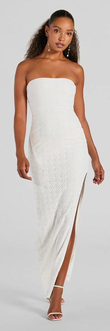 Essential for vacations or summer days, the Tuscan Charm Strapless Slit Eyelet Maxi Dress is a sundress or milkmaid dress with sleek and flirty details.