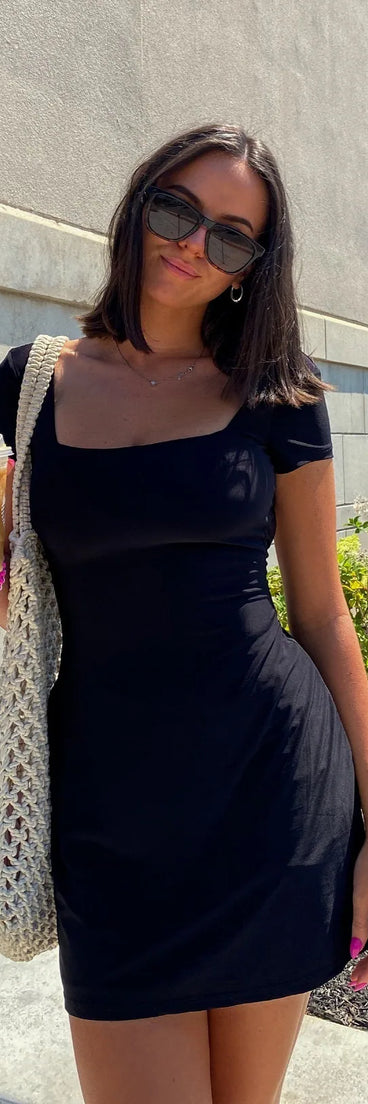 Soak up the season in the Must-Have Tie Back A-Line Mini Dress, a black sundress styled for easy days, outdoor plans, and everything in between.