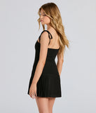 The Dream Twirl Tie Strap Pleated A-Line Mini Dress in black brings edge and energy to your vibe, ready to elevate any festival look or concert outfit.
