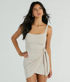 The Forever Chic Sleeveless Wrap Mini Dress in natural brings edge and energy to your vibe, ready to elevate any festival look or concert outfit.