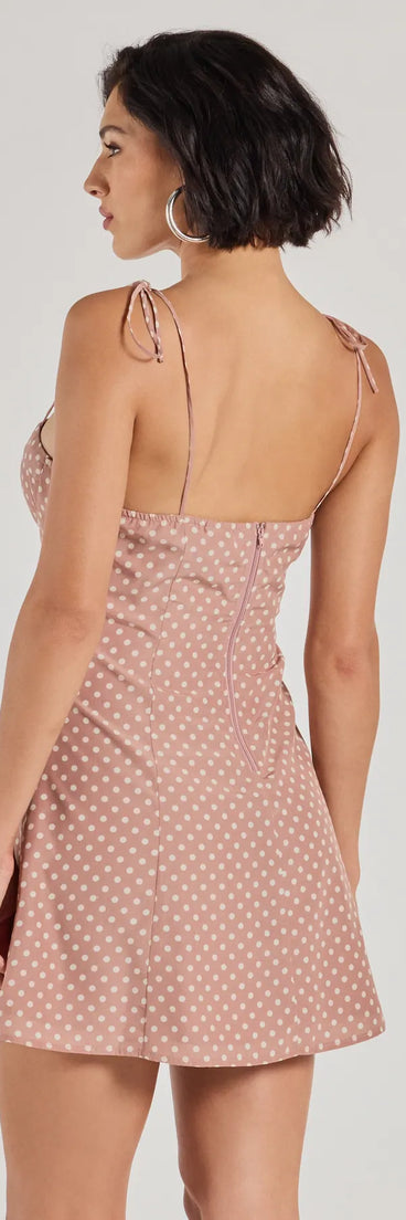 The Perfectly Poised Sweetheart Polka Dot A-Line Dress is a mini dress in peach, perfect for an above-the-knee holiday party dress or a stylish NYE look, with a short hemline designed to make a winter statement.