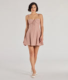 The Perfectly Poised Sweetheart Polka Dot A-Line Dress is a stunning peach mini dress with a short hem, designed to be the perfect winter cocktail dress or night-out look for the holiday season.