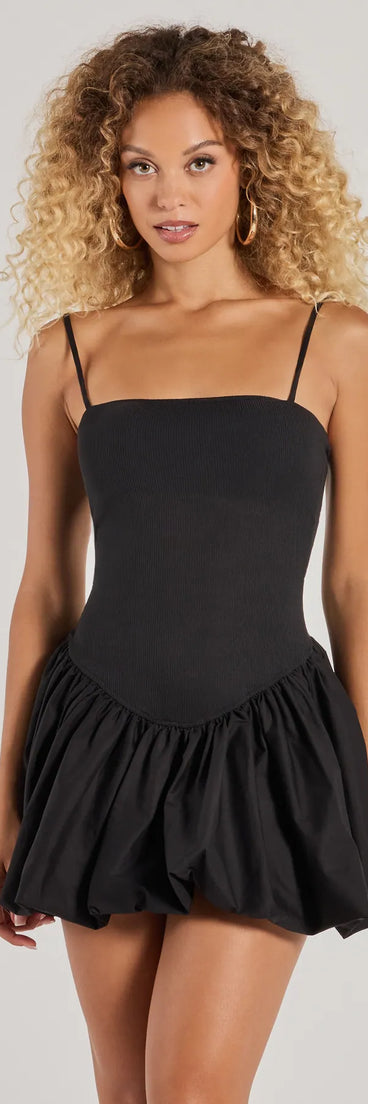 Step into seasonal chic with the Flirty Babe Drop Waist Bubble Hem Skater Dress, a black mini dress featuring an above-the-knee cut ideal for cocktail parties, festive gatherings, or clubwear.