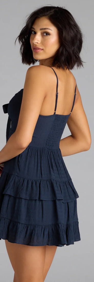 The So Effortless Tie-Front Ruffled Skater Dress in navy blue brings sleek style to any graduation outfit, from cap and gown to after-party.