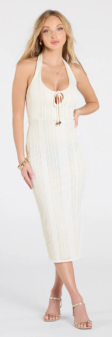 Make a bold statement in the Vacay Escape Halter Bodycon Crochet Midi Dress in ivory, the perfect summer dress for weddings, cocktail hours, nights out, and/or seasonal celebrations.