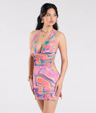 The Bring The Heat Halter Open Back Abstract Mini Dress in pink brings edge and energy to your vibe, ready to elevate any festival look or concert outfit.