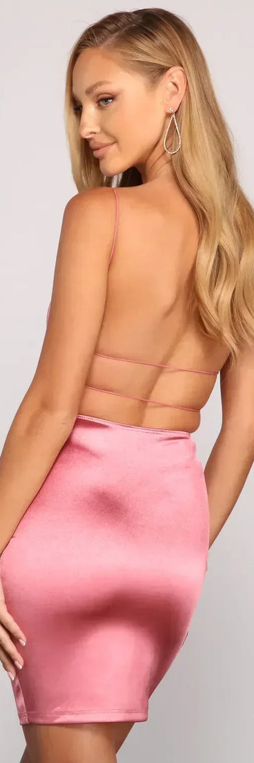 The Sleek and Stunning Satin Mini Dress is a mini dress in mauve, perfect for an above-the-knee holiday party dress or a stylish NYE look, with a short hemline designed to make a winter statement.