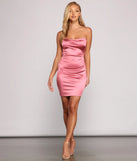 The Sleek and Stunning Satin Mini Dress is a stunning mauve mini dress with a short hem, designed to be the perfect winter cocktail dress or night-out look for the holiday season.