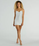 The Occasion For Sparkle Rhinestone Mini Party Dress is a stunning white mini dress with a short hem, designed to be the perfect winter cocktail dress or night-out look for the holiday season.