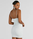 Revamp your 2025 wardrobe with this chic addition, the Glitzy Shine Twist-Front Glitter Mini Dress in white, perfect for elevating your style in the new year.