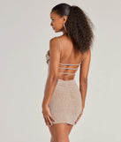 Revamp your 2025 wardrobe with this chic addition, the Glitzy Allure Glitter Strappy Back Mini Dress in taupe, perfect for elevating your style in the new year.