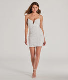 Make a bold statement in the Glitzy Glimmer Rhinestone And Pearl Bodycon Mini Dress in white, the perfect summer dress for weddings, cocktail hours, nights out, and/or seasonal celebrations.