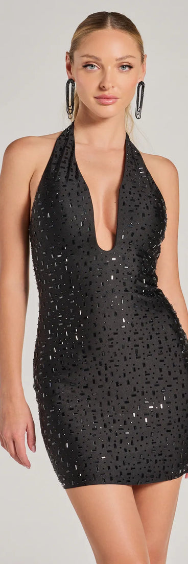 Step into seasonal chic with the Edgy Glamour Rhinestone Halter Bodycon Mini Dress, a black mini dress featuring an above-the-knee cut ideal for cocktail parties, festive gatherings, or clubwear.