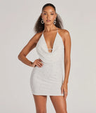 Step into winter chic with the Upscale Company Cowl Halter Faux Pearl Mini Dress, a white mini dress featuring an above-the-knee cut ideal for cocktail parties, festive gatherings, or clubwear.