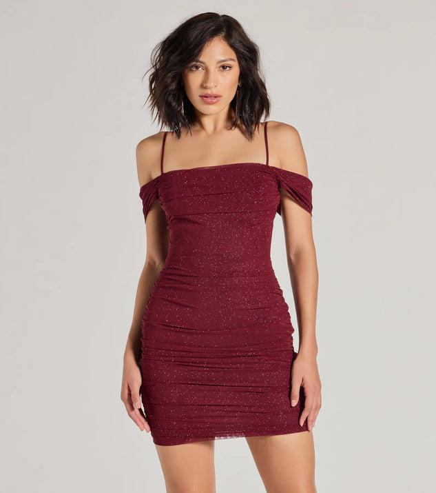 Step into seasonal chic with the Glam Affair Cold-Shoulder Glitter Mesh Mini Dress, a raisin purple mini dress featuring an above-the-knee cut ideal for cocktail parties, festive gatherings, or clubwear.