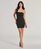 Make a bold statement in the Under The Spotlight Sleeveless Glitter Mini Tube Dress in black, the perfect summer dress for weddings, cocktail hours, nights out, and/or seasonal celebrations.