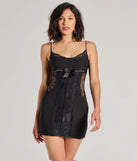 Step into winter chic with the Sealed With Style Lace and Bow Mini Dress, a black mini dress featuring an above-the-knee cut ideal for cocktail parties, festive gatherings, or clubwear.