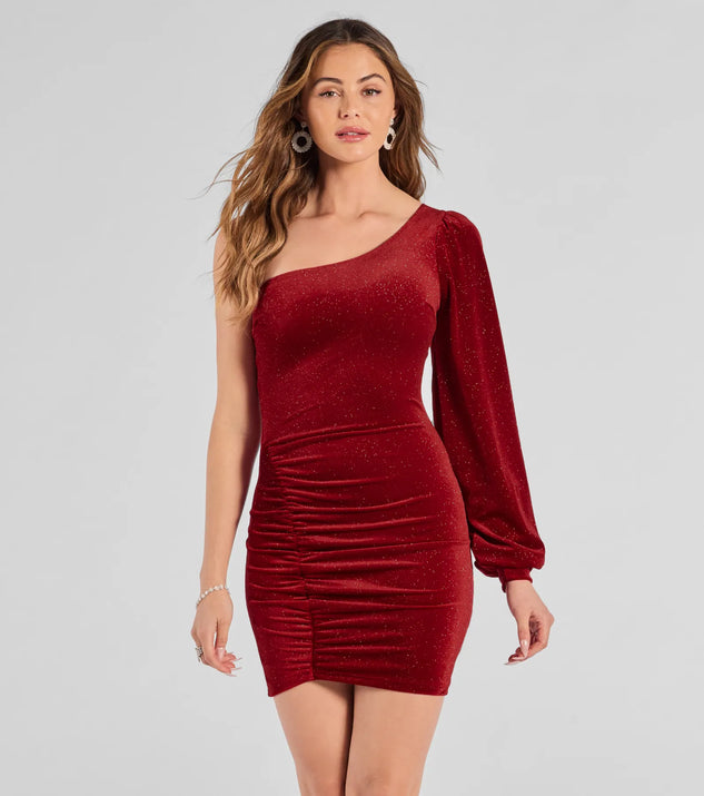 The Luxe Alluring Glitter Velvet One-Shoulder Mini Dress in red is a modern red dress featuring trendy details and a stunning design ideal for wedding guest dresses, elegant cocktail looks, or an alluring party dress.