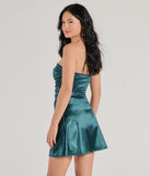 Make a bold statement in the Perfect Glow Strapless Pleat A-Line Satin Mini Dress in hunter green, the perfect green dress for weddings, cocktail hours, nights out, and/or seasonal celebrations.
