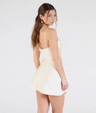 The Sleek Sophistication A-Line Pleated Mini Dress in ivory brings sleek style to any graduation outfit, from cap and gown to after-party.