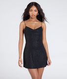 Make a bold statement in the Unforgettable Heat Open Strappy Back Glitter Mini Dress in black, the perfect summer dress for weddings, cocktail hours, nights out, and/or seasonal celebrations.