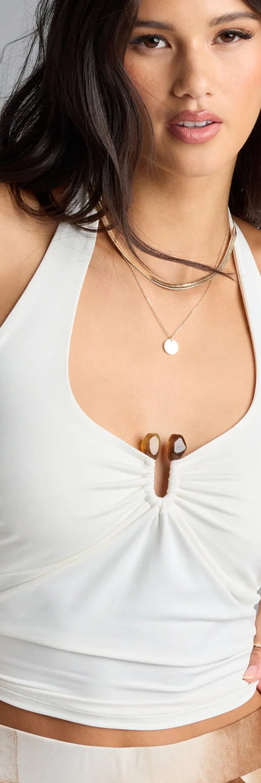 The Feelin' The Heat Halter Crop Top in white brings edge and energy to your vibe, ready to elevate any festival look or concert outfit.