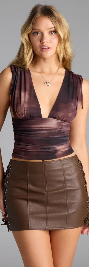 With its midriff cut and trend-forward fit, the Up A Notch Plunge Abstract Crop Top is a brown crop top made to pair with skirts, denim, or whatever vibe you're feeling this season.