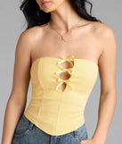 With its midriff cut and trend-forward fit, the Posh And Pretty Strapless Bow Ponte Crop Top is a yellow crop top made to pair with skirts, denim, or whatever vibe you're feeling this season.