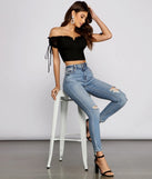 The Hooked In Ruched Crop Top in black is a women's workwear piece offering a trendy style and unique accents, perfect for effortlessly creating an outfit-of-the-day look that transitions your office look to going-out ready.