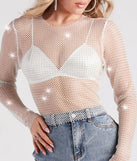 The Glitzy Muse Rhinestone Fishnet Crop Top in white is a sequin top with an all-over sparkle, perfect for creating a glam concert outfit or adding shimmer to a going-out look. 