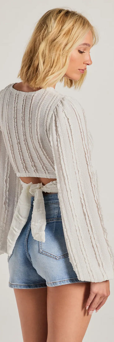 Stand out in 2025 in the Romance Awaits Long Sleeve Ruffle Lace Trim Crop Top, a women's ivory long-sleeve top crafted from an elevated fabric with a modern neckline perfect for party outfits, bridal shower attire, or elevated casual outfits.