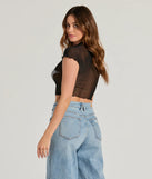 The Born Star Rhinestone Sheer Mesh Crop Top in black is a holiday-ready sequin top with an all-over sparkle, perfect for creating a glam NYE outfit or adding shimmer to a festive holiday look. 
