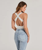 Elevate your winter outfits with the Stunning Persuit Sleeveless Cross Back Bodysuit, a ivory bodysuit designed for confident and effortless styling with anything from mini skirts to high-waist jeans.