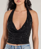 The Glitzy Chic Cropped Rhinestone Halter Top in black is a sequin top with an all-over sparkle, perfect for creating a glam concert outfit or adding shimmer to a going-out look. 
