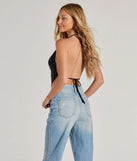 The Sparkly Glitz Rhinestone Halter Crop Top in black is a sequin top with an all-over sparkle, perfect for creating a glam concert outfit or adding shimmer to a going-out look. 